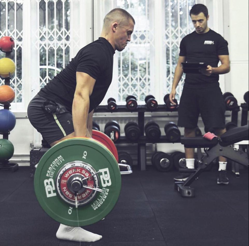 Male trap bar deadlifting